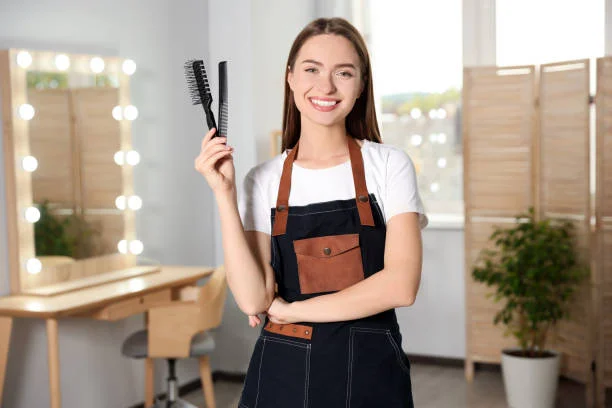Portrait of happy hairdresser with comb and brush in beauty salon SEO Services For Salon Business